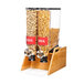 A Rosseto double cereal dispenser with glass canisters on a bamboo stand.