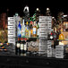 A table with the Rosseto Skycap riser holding a variety of bottles and glasses.
