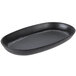 A black oval cast iron pan with a black rim.
