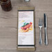A Menu Solutions weathered walnut wood menu board on a table in an Italian restaurant.