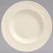 A Libbey cream white china pasta bowl with a swirl design on it.
