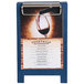 A Menu Solutions blue wood menu board tent with clip on a table with a glass of red wine.