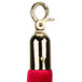 A close-up of a red velvet rope with brass ends.