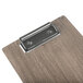 A Menu Solutions weathered walnut wood clipboard with a black metal clip.