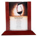 A Menu Solutions mahogany wood table tent with a 4x6 insert slot on a table with a glass of wine.