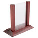 A mahogany wood menu holder/tent with insert slot on a table.