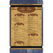 A white Menu Solutions wood menu board with blue and brown denim straps.