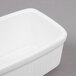A white rectangular Tuxton china container with a rounded edge and a lid.