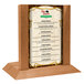 A Menu Solutions oak wood table tent with a slot for a 4" x 6" insert on a table.