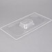 A clear plastic food pan lid with a square shape on top.