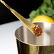 A Barfly gold plated Japanese style bar spoon with a jam on it.