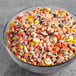 Chopped REESE'S PIECES® in a bowl on a table.