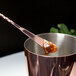 A copper plated Barfly Japanese style bar spoon in a metal cup.