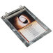 An Alumitique aluminum menu board with swirl finish and rings holding a menu.
