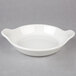 A Hall China au gratin dish with white surface and handles.