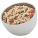 A Vollrath double wall metal bowl filled with pasta, vegetables, and tomatoes.