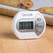 A Taylor 5806 digital kitchen timer with a cookie on it.