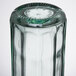 An Arcoroc Swing Top tinted green glass bottle.
