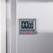 The digital display of a Cooper-Atkins kitchen timer with white numbers on a silver surface.