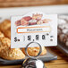 A Choice bakery deli tag wheel on a counter with a price tag for bakery items.