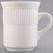 An 8 oz. ivory (American white) china mug with an embossed rim and a handle.