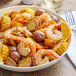 A bowl of shrimp, corn, and potatoes with Regal Upper Bay Crab Mix spices.