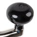 A black knob on a metal handle.
