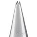A silver metal cone shaped Ateco piping tip with a small hole.