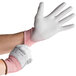 A person wearing Cordova Machinist cut resistant gloves with a gray polyurethane palm.