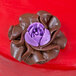 A purple chocolate flower made with an Ateco Russian Piping Tip.