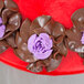 A close up of chocolate roses piped with an Ateco Russian piping tip.