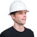 A man wearing a white Cordova Duo full-brim hard hat and smiling.