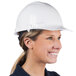 A woman wearing a white Cordova Duo Safety hard hat.