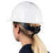 A woman wearing a white Cordova Duo Safety hard hat with a ponytail.