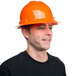 A man wearing a Cordova Duo orange hard hat smiles.