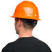 A man wearing a Cordova Duo orange hard hat.