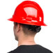 A man wearing a Cordova red full-brim hard hat.