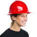 A woman wearing a Cordova red hard hat with a smile.