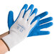 A person wearing Cordova Cor-Grip gloves with blue latex palms.