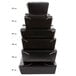 A stack of black Fold-Pak Bio-Pak take-out boxes on a table.
