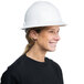 A woman wearing a Cordova Duo Safety white full-brim hard hat with 6-point ratchet suspension.