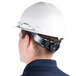 A man wearing a Cordova Duo Safety white hard hat.