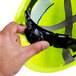 A hand holding a Cordova Duo Safety Hi-Vis Green cap style hard hat.