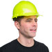 A man wearing a green hard hat.