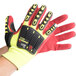 A close up of a yellow and red Cordova OGRE-CR+ safety glove with TPR reinforcements.