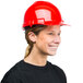 A woman wearing a Cordova red cap style hard hat.