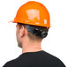 A man wearing a Cordova Safety Orange hard hat.