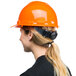 A woman wearing a Cordova orange cap style hard hat with a black ponytail.