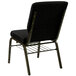 A Flash Furniture black church chair with a gold metal frame and dot patterned fabric.