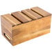 A Tablecraft acacia wood serving crate with four compartments on a table.